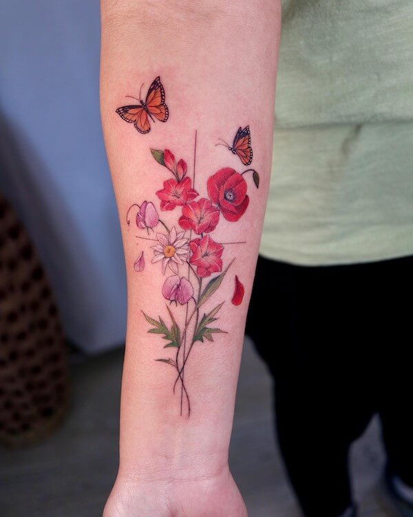 Cross Butterfly And Flower Arm Tattoo