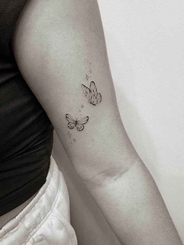 Two Butterflies Flying On The Upper Arm