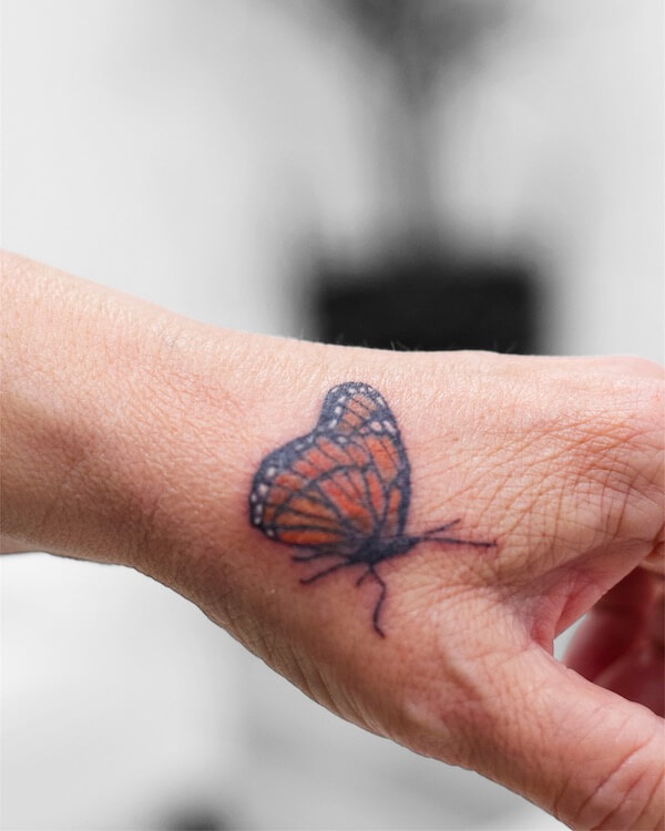Colorful Butterfly Tattoo On The Side Of The Hand