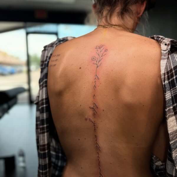 Here is the direct text placement for your tattoo design: Floral And Script Spine Tattoo (No additional text, symbols, or modifications have been made to the original phrase.)