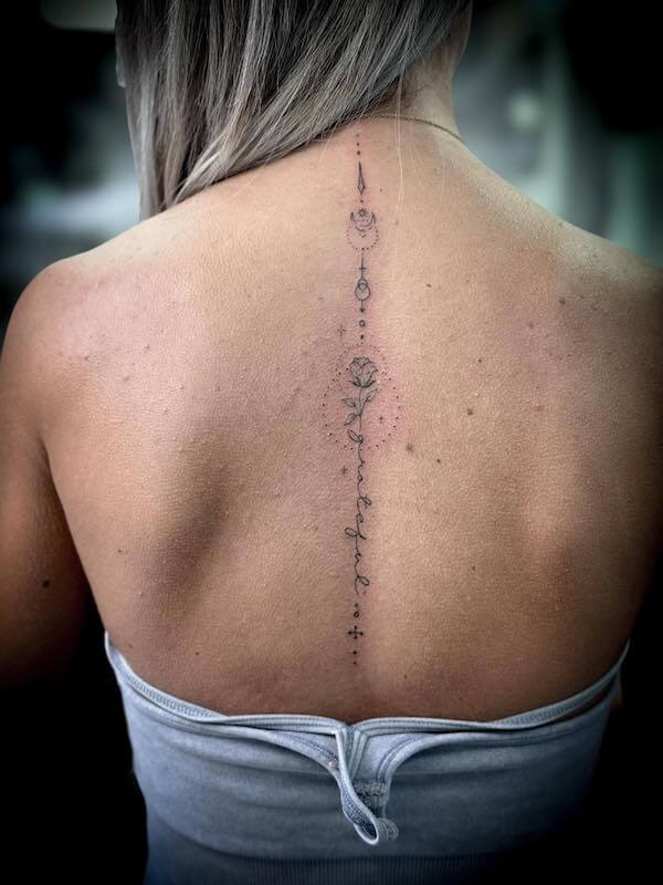 Romantic Floral And Lettering Spine Tattoo