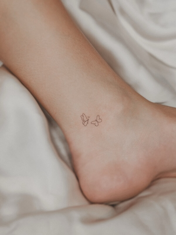 Minimalist Butterfly Ankle Tattoo