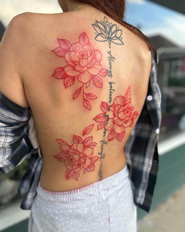 Black Lotus And Script Spine Tattoo