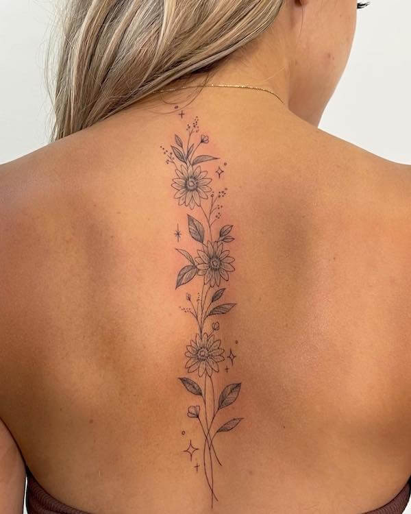 Elegant Daisy Spine Tattoo